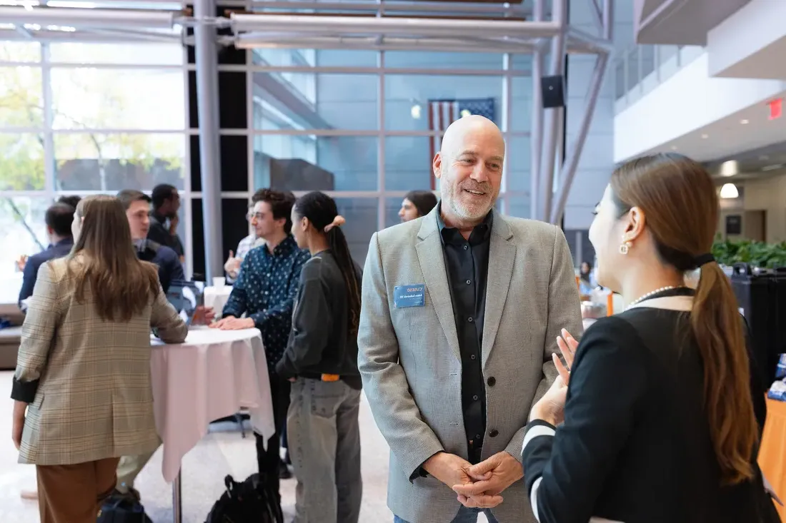 A student with an alum at a net工作ing event.